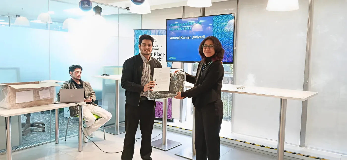 Anuraj receiving an award in the office