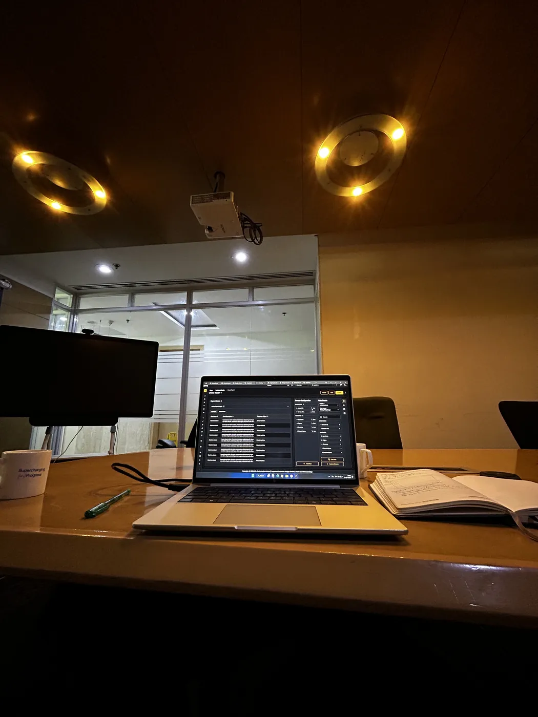 A laptop showing a dashboard on a meeting-room desk