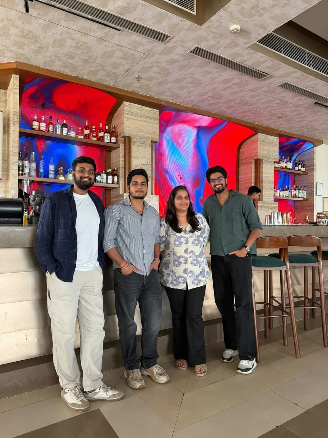 Anuraj with two colleagues at a bar