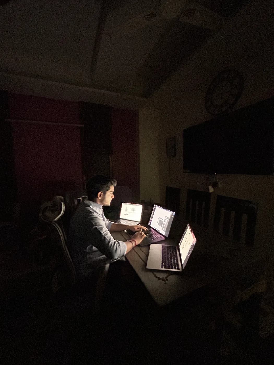 A late night working across three laptops