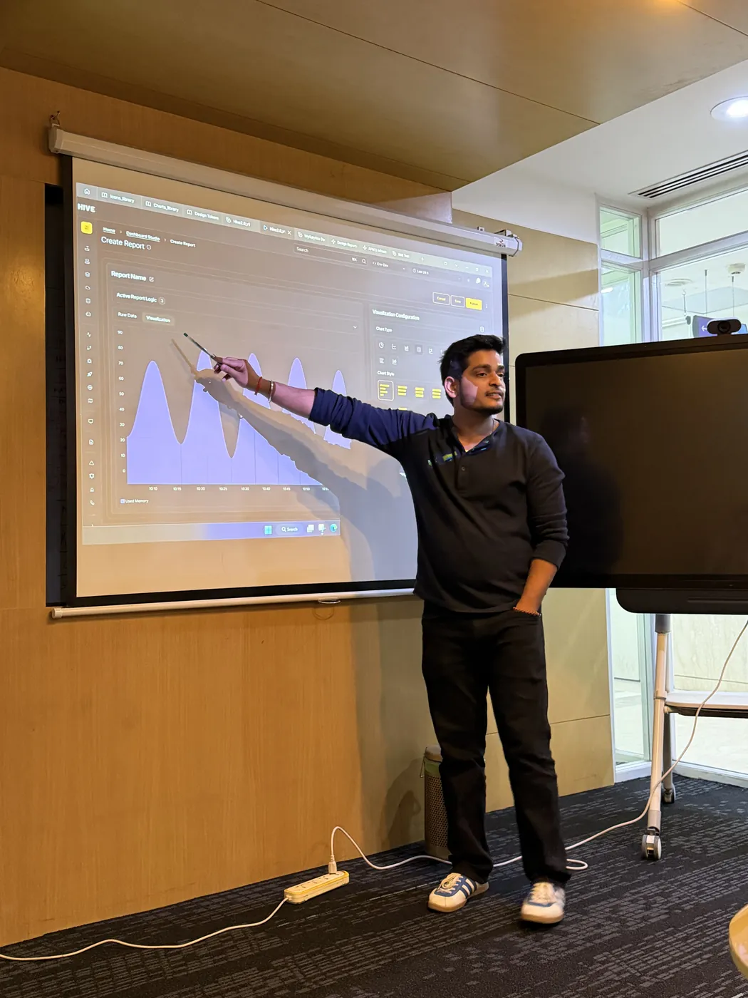 Anuraj presenting a chart on the projector screen
