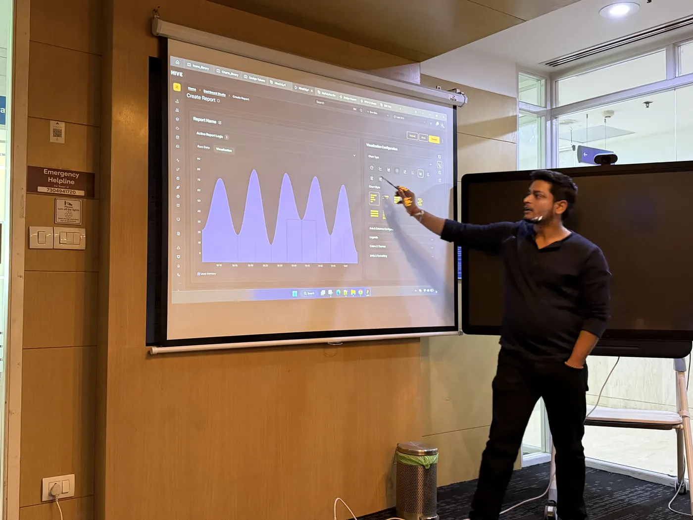 Anuraj pointing at a chart during a presentation