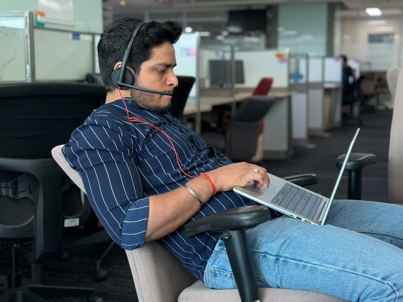 Anuraj working on a laptop in the office